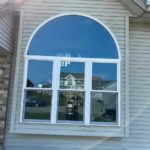 Outside view of a new window replaced by Semperfi Roofing in Oak Creek, WI