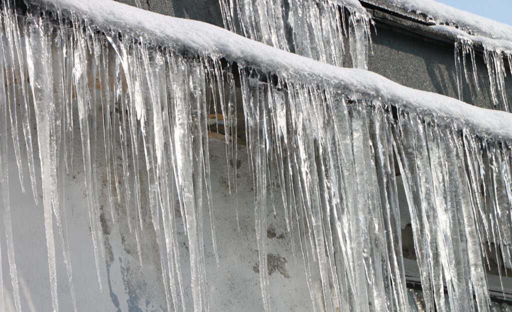 ice dam that needs removed before causing permanent roof and gutter damage