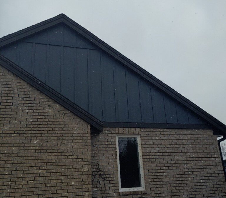 http://New%20dark%20blue%20siding%20on%20the%20side%20and%20attic%20of%20a%20home