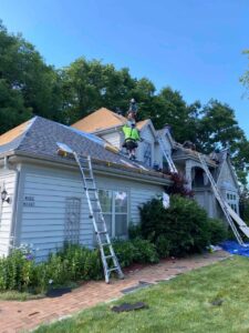 why you should get a roof replacement. guys from Semper Fi working on a roof to keep it maintained