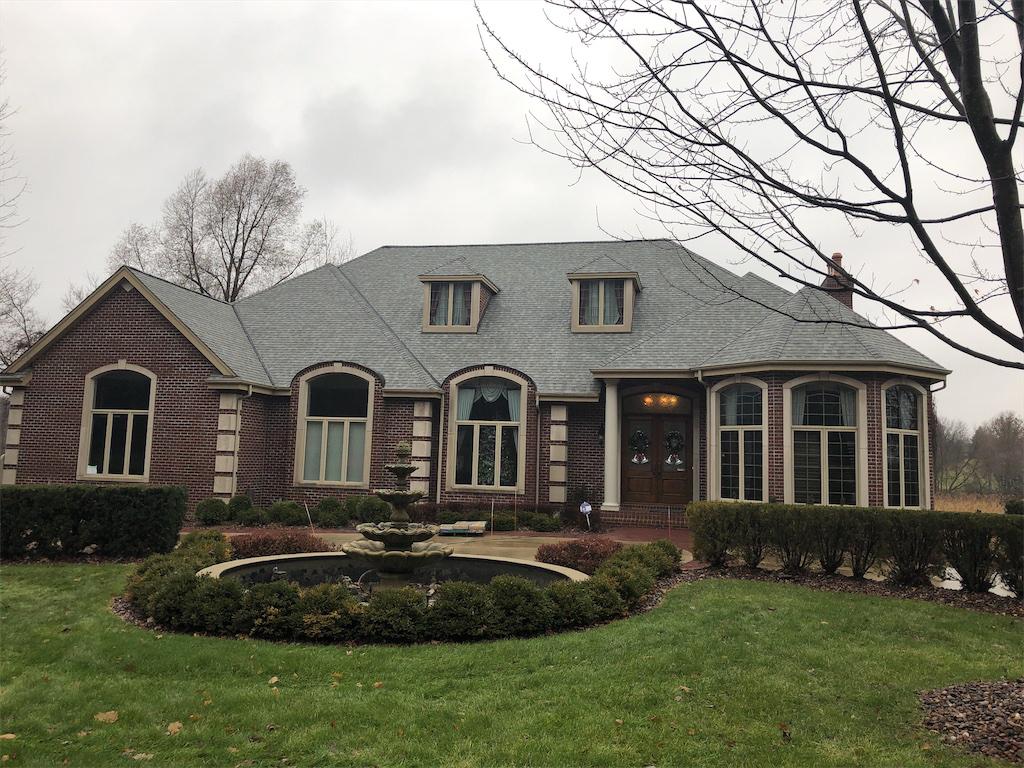 A house in Menomonee Falls, WI with an aphalt roof and brick siding
